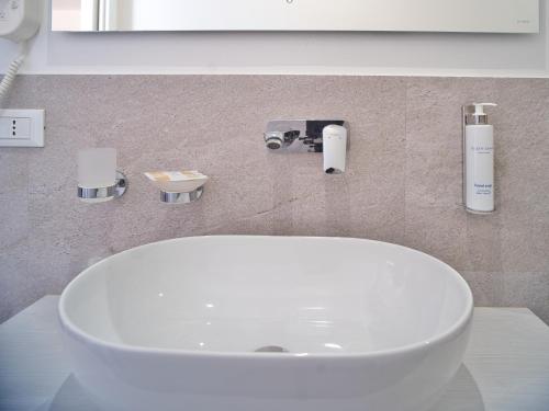 a bathroom with a white sink and a mirror at Hotel Medusa in Finale Ligure