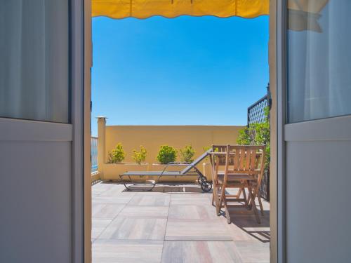 an open door to a patio with a table and chairs at Hotel Medusa in Finale Ligure