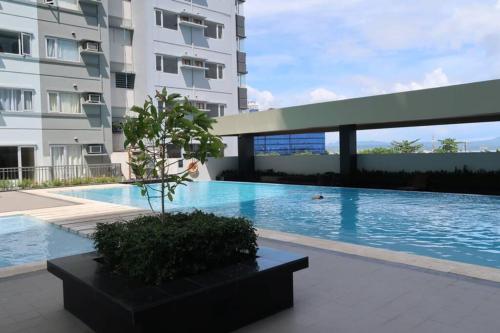 a swimming pool in front of a building at "Stylish Loft Condo with High-Speed WiFi at Avida Towers" in Davao City