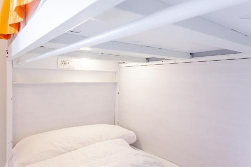 a bedroom with white walls and a bed at El Albergue de Sigüenza in Sigüenza