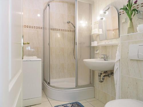 a bathroom with a shower and a toilet and a sink at Müggenburger Weg 1 Whg 1 in Zingst