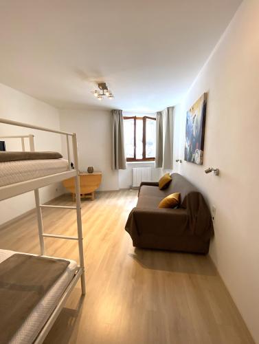 a living room with a couch and a bunk bed at Residence Foemina 65 Val di Luce in Abetone