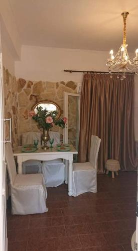 a room with a table and chairs and a mirror at Villa Trypitos in Sitia
