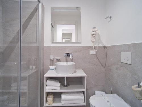 a bathroom with a sink and a shower at Hotel Medusa in Finale Ligure