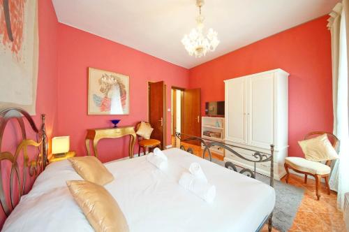 a bedroom with a white bed and red walls at DolceVita Apartments N. 488 in Venice