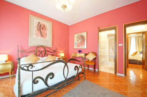 a bedroom with pink walls and a bed in a room at DolceVita Apartments N. 488 in Venice