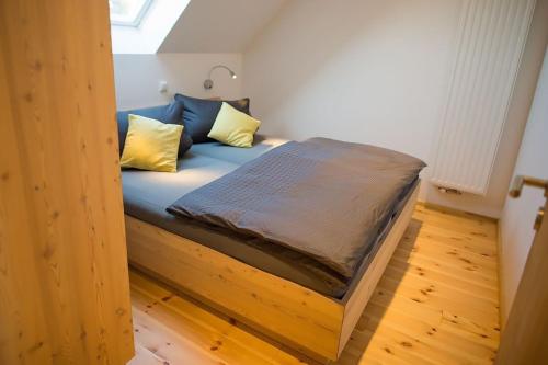 a bed in a room with a wooden floor at Ferienwohnung 3 in Hoyerswerda