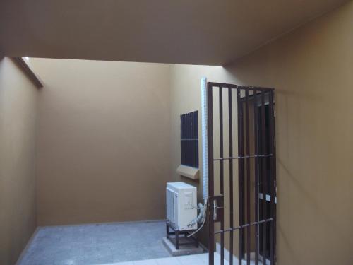 a room with a iron gate with a heater at Residence Japoma in Douala