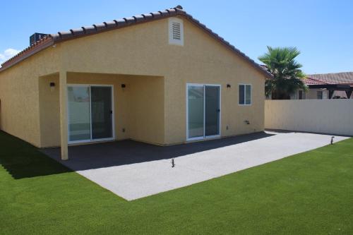 a house with a green lawn in front of it at Newly Remodeled Family Friendly 3B/2B House in Henderson