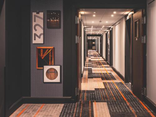 a hallway with black walls and yellow and black tiles at Novotel Paris Vaugirard Montparnasse in Paris