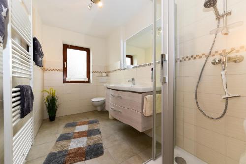 a bathroom with a sink and a shower at Schleswig-Holstein Whg 04 OG re in Nieblum
