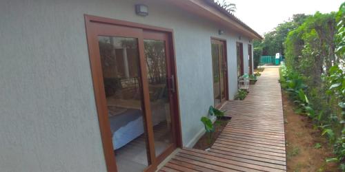 a house with glass doors and a wooden porch at Pousada Maresia in Fernando de Noronha