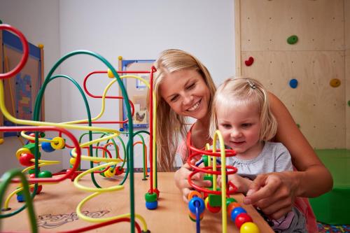a woman and a little girl playing with toys at Apartment S in Ehrwald