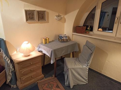 a room with a table with a lamp and a chair at Villa Petterhof in Schottwien