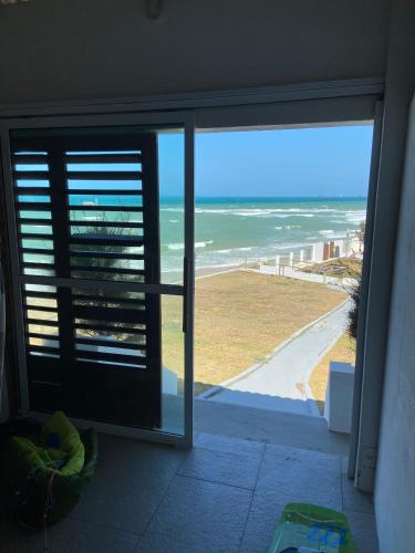 a room with a view of the ocean from a window at WegoKite Stars in Taíba