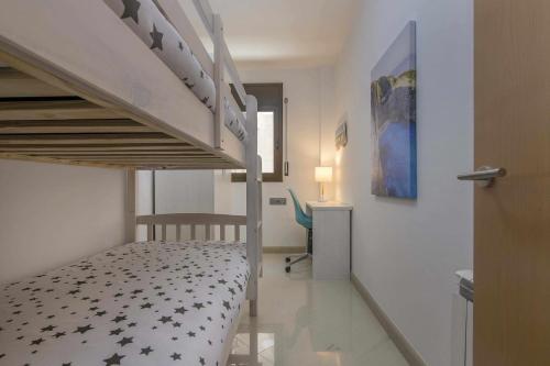 a small bedroom with a bunk bed and a desk at Kisa Apartments de Manresa in Manresa