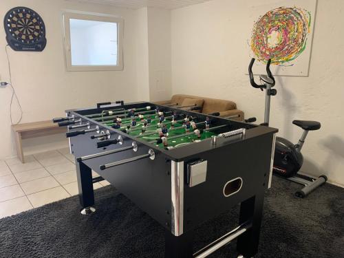 a foosball table in a living room at Allgäu Apartment in Memmingen