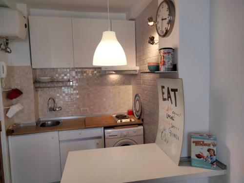 a small kitchen with a sink and a refrigerator at Apartamento Toñi in Las Palmas de Gran Canaria