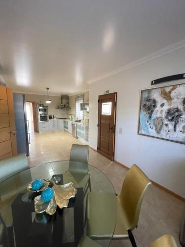 a living room with a glass table and chairs at Villa Mar Azul in Albufeira