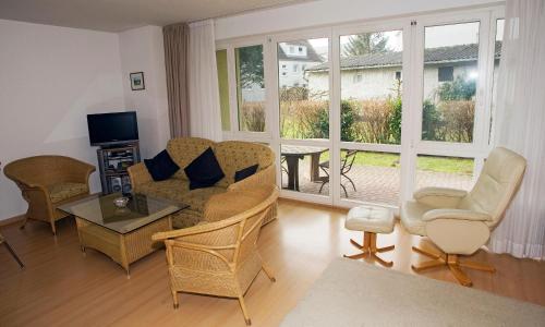 a living room with a couch and chairs and a television at Likedeeler Weg 1 Whg 18 in Zingst