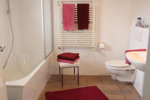a bathroom with a tub and a toilet and a sink at Ostseeresidenz - Whg 24 in Zingst