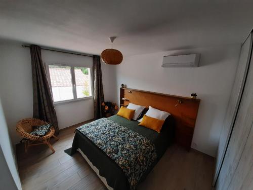 a bedroom with a bed and a window at Villa_Culomba ALATA -T2 4 couchages in Alata