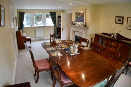 a dining room with a wooden table and chairs at Stanton House Annex in Bakewell