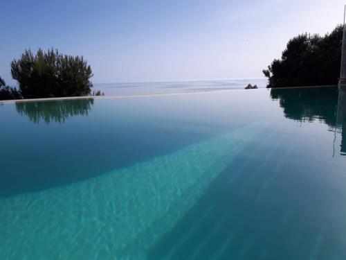 a swimming pool with the ocean in the background at Villa Luxury Paradise Suites in Salobreña
