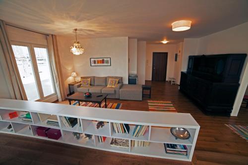 a living room with a couch and a tv at Arena Penthouse Apartments in Belgrade