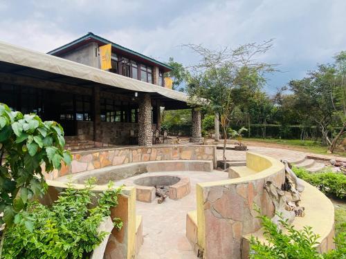 a building with a fountain in front of it at Oldarpoi Wageni Camps in Keekorok
