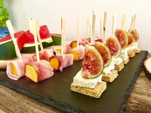 a row of sandwiches with fruit on skewers on a table at Alla Riva in Verona