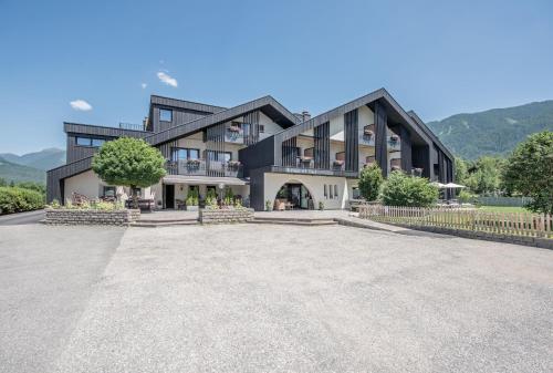 a large black building with a large driveway at Hotel Krondlhof in Brunico