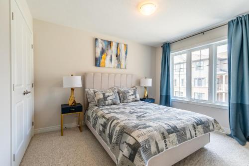 1 dormitorio con cama y ventana en GLOBALSTAY Modern Townhomes in Lakeshore Steps to the Beach, en Hamilton