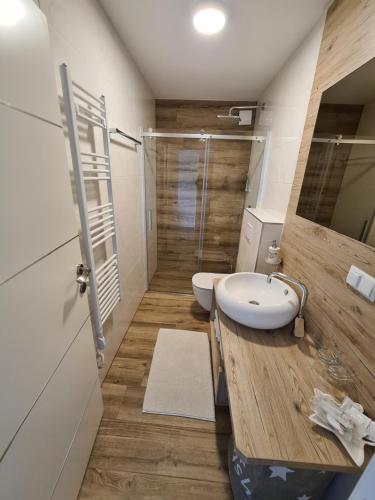 a bathroom with a white sink and a shower at Villa Patricia in Stari Grad