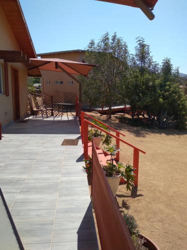 a porch with potted plants on a house at Posada Soleil Bed & Breakfast in Valle de Guadalupe