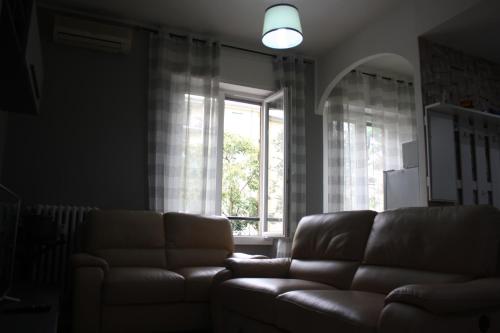 a living room with a couch and a window at My Home Milano ! in Milan