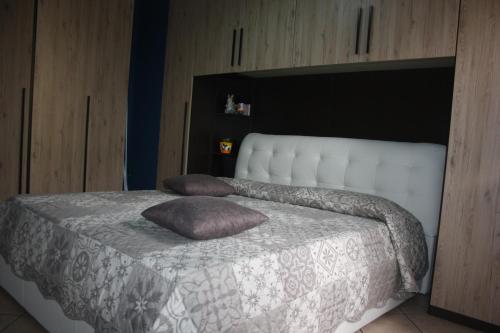 a bedroom with a bed with two pillows on it at My Home Milano ! in Milan