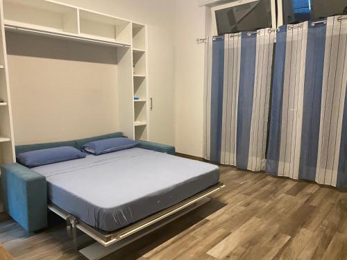 a bedroom with a bed with blue pillows on it at Monolocale Agata in Sestri Levante