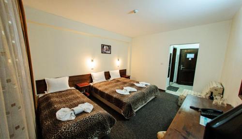 Postel nebo postele na pokoji v ubytování Hotel Dumanov