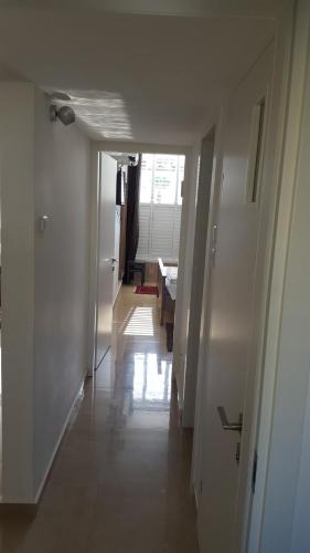 a hallway leading to a living room and a dining room at Room near Sheba Medical Center, and Bar Ilan, and TLV Airport in Qiryat Ono