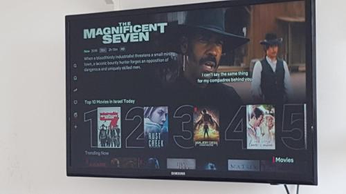a television screen with a movie on it at Room near Sheba Medical Center, and Bar Ilan, and TLV Airport in Qiryat Ono