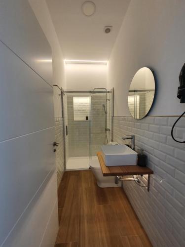 a bathroom with a shower and a sink and a mirror at REDONDELA APARTMENTS - Bedroom, Bathroom & Kitchen in Redondela