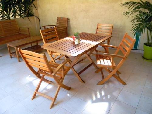 a wooden table with four chairs and a table and a table and chairsktop at Case Fiorite in Riola Sardo
