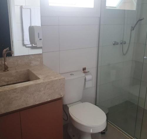a bathroom with a toilet and a shower and a sink at Casa Nova Canela Condominio Fechado 40 in Canela