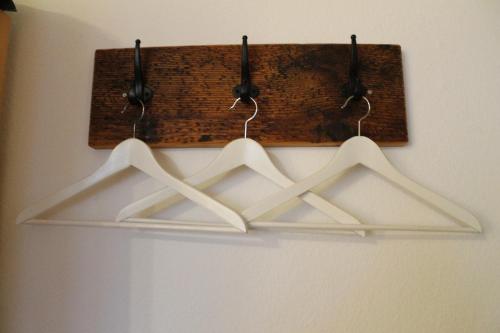 three white hangers hanging on a wall at Ferienhof Wuchner - Fewo "Frühlingserwachen" in Fröhnd