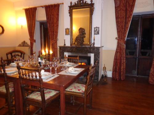 a dining room with a table and a fireplace at Maison Forestière in Veyras