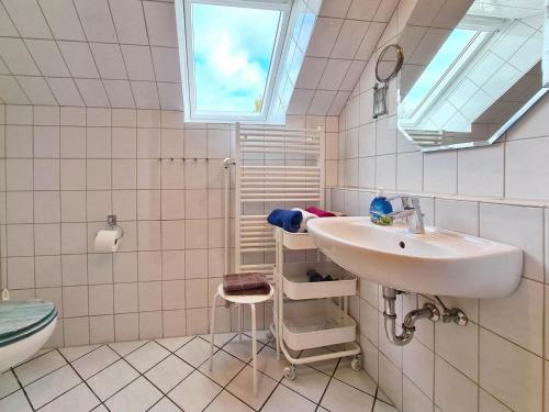 a bathroom with a sink and a toilet and a window at TausendSchön in Vadersdorf