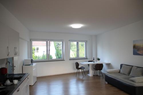 a living room with a couch and a table at Casa Kronengarten Nr 11 in Hilden