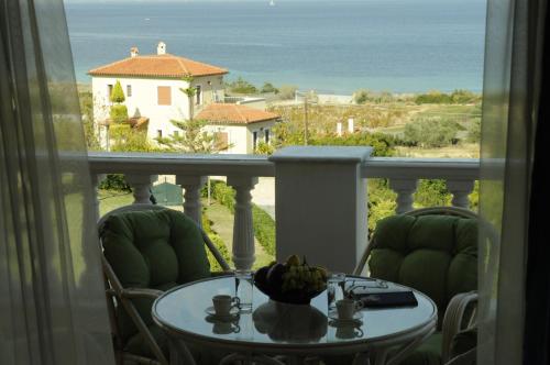 a table with a bowl of fruit on top of a balcony at Bella Villa in Vaia
