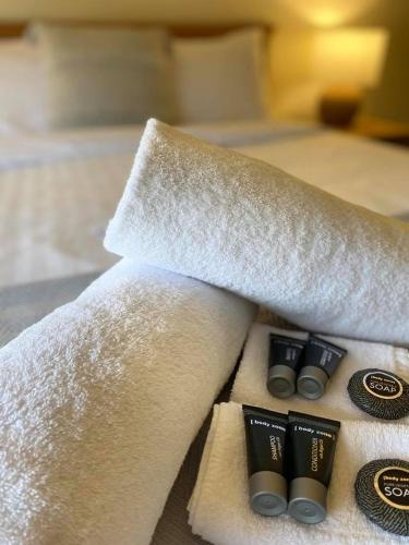 a hotel room with white towels and two pillows at Pedder Wilderness Lodge in Strathgordon